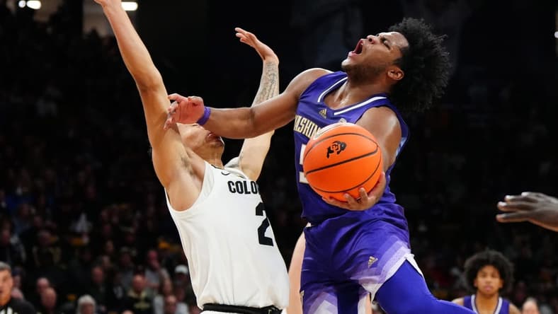 Dec 29, 2023; Boulder, Colorado, USA; Washington Huskies guard Sahvir Wheeler (5) shoots the ball at Colorado Buffaloes guard KJ Simpson (2) in the first half at the CU Events Center. Mandatory Credit: Ron Chenoy-USA TODAY Sports