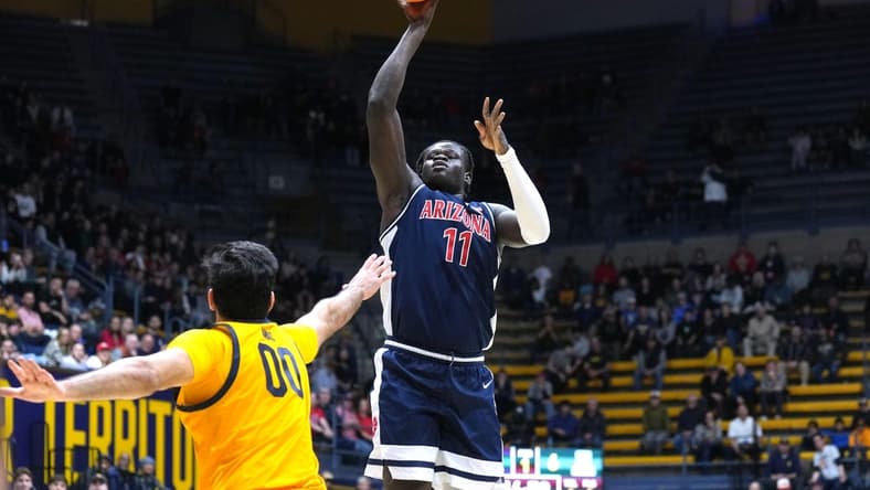 Dec 29, 2023; Berkeley, California, USA; Arizona Wildcats center Oumar Ballo (11) shoots against California Golden Bears forward Fardaws Aimaq (00) during the first half at Haas Pavilion. Mandatory Credit: Darren Yamashita-USA TODAY Sports