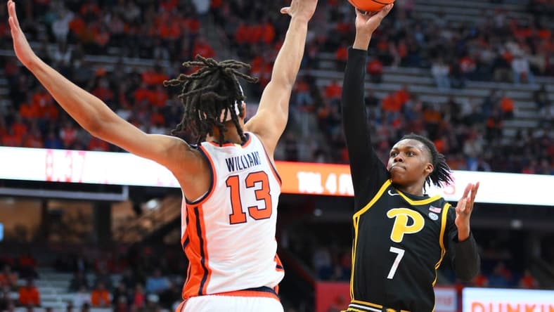 Dec 30, 2023; Syracuse, New York, USA; Pittsburgh Panthers guard Carlton Carrington (7) shoots as Syracuse Orange forward Benny Williams (13) defends during the first half at the JMA Wireless Dome. Mandatory Credit: Rich Barnes-USA TODAY Sports