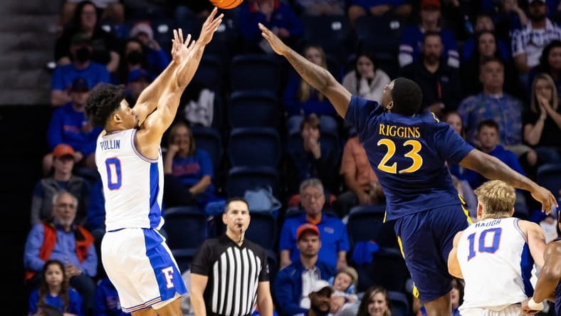 Dec 30, 2023; Gainesville, Florida, USA; Florida Gators guard Zyon Pullin (0) shoots over Quinnipiac Bobcats forward JJ Riggins (23) during the first half at Exactech Arena at the Stephen C. O'Connell Center. Mandatory Credit: Matt Pendleton-USA TODAY Sports
