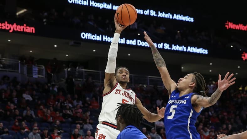 Dec 30, 2023; Elmont, New York, USA;  St. John's Red Storm guard Daniss Jenkins (5) shoots past Hofstra Pride guard Jaquan Carlos (5) in the second half at UBS Arena. Mandatory Credit: Wendell Cruz-USA TODAY Sports