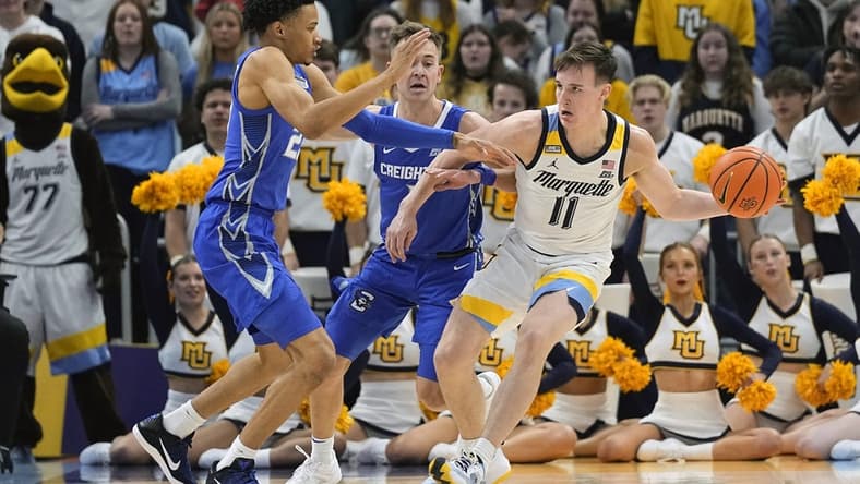 Dec 30, 2023; Milwaukee, Wisconsin, USA;  Marquette Golden Eagles guard Tyler Kolek (11) looks to pass the ball while under pressure from Creighton Bluejays guard Trey Alexander (23) during the first half at Fiserv Forum. Mandatory Credit: Jeff Hanisch-USA TODAY Sports