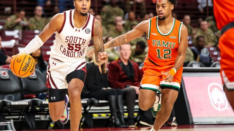 Dec 30, 2023; Columbia, South Carolina, USA; South Carolina Gamecocks guard Ta'Lon Cooper (55) drives around Florida A&M Rattlers guard K'Jei Parker (12) in the first quarter at Colonial Life Arena. Mandatory Credit: Jeff Blake-USA TODAY Sports