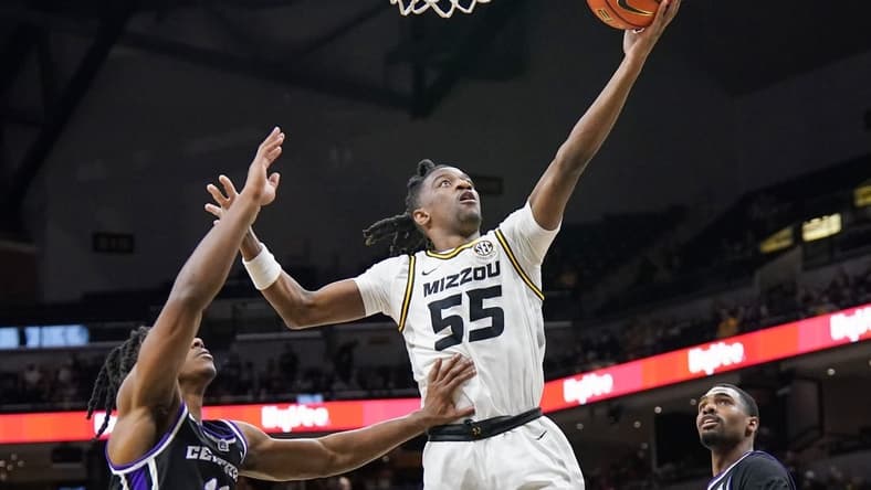 Dec 30, 2023; Columbia, Missouri, USA; Missouri Tigers guard Sean East II (55) scores as Central Arkansas Bears guard Carl Daughtery Jr. (11) defends during the first half at Mizzou Arena. Mandatory Credit: Denny Medley-USA TODAY Sports