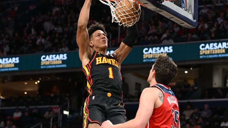 Dec 31, 2023; Washington, District of Columbia, USA; Atlanta Hawks forward Jalen Johnson (1) dunks the ball as Washington Wizards center Mike Muscala (35) looks on during the first half at Capital One Arena. Mandatory Credit: James A. Pittman-USA TODAY Sports