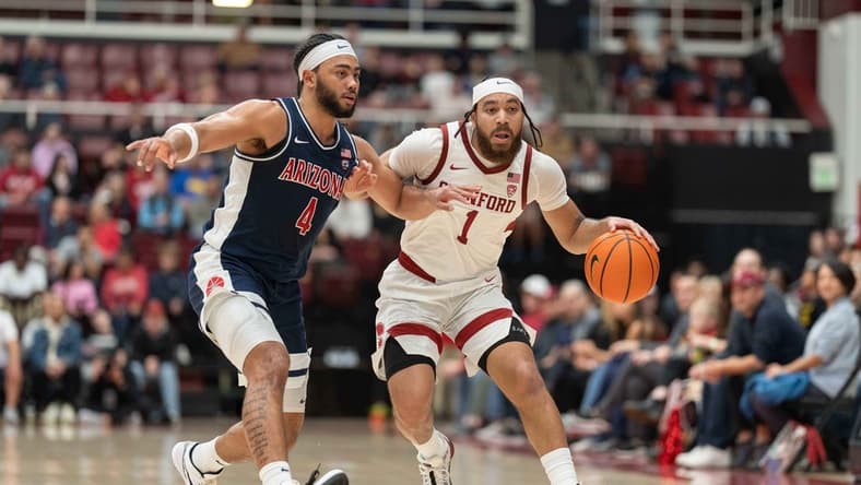 Dec 31, 2023; Stanford, California, USA; Stanford Cardinal guard Jared Bynum (1) drives the ball against Arizona Wildcats guard Kylan Boswell (4) during the first half at Maples Pavilion. Mandatory Credit: Stan Szeto-USA TODAY Sports