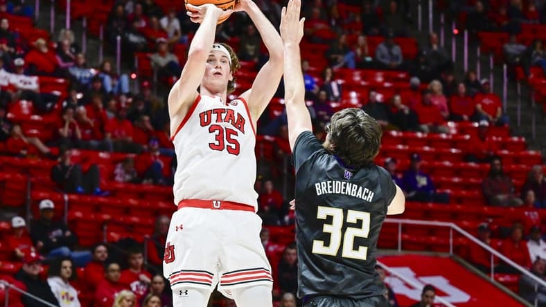 Dec 31, 2023; Salt Lake City, Utah, USA; Utah Utes center Branden Carlson (35) takes a shot over Washington Huskies forward Wilhelm Breidenbach (32) during the first half at the the Jon M. Huntsman Center. Mandatory Credit: Christopher Creveling-USA TODAY Sports