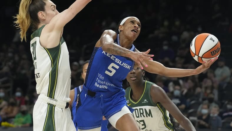 Aug 12, 2021; Phoenix, Arizona, USA; Connecticut Sun guard Jasmine Thomas (5) drives against Seattle Storm forward Breanna Stewart (30) in the second half during the Inaugural WNBA Commissioners Cup Championship Game at Footprint Center. Mandatory Credit: Rick Scuteri-USA TODAY Sports