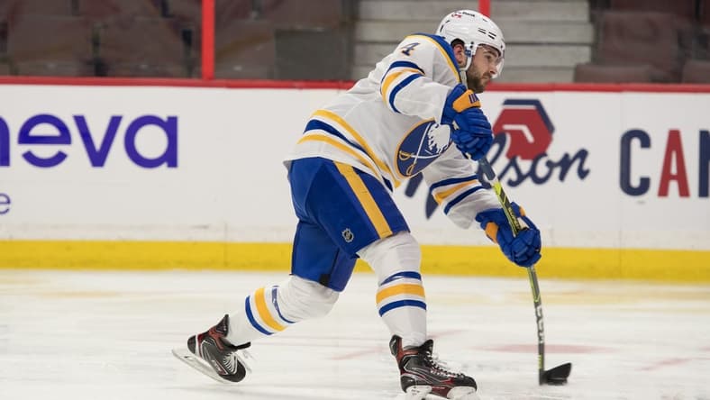 Jan 18, 2022; Ottawa, Ontario, CAN; Buffalo Sabres defenseman Will Butcher (4) shoots the puck in the second period against the Ottawa Senators at the Canadian Tire Centre. Mandatory Credit: Marc DesRosiers-USA TODAY Sports