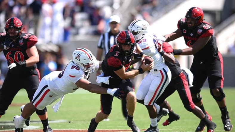 Sep 3, 2022; San Diego, California, USA; San Diego State Aztecs quarterback Braxton Burmeister (5) is tackled by Arizona Wildcats defensive lineman Tiaoalii Savea (98) during the second half at Snapdragon Stadium. Mandatory Credit: Orlando Ramirez-USA TODAY Sports