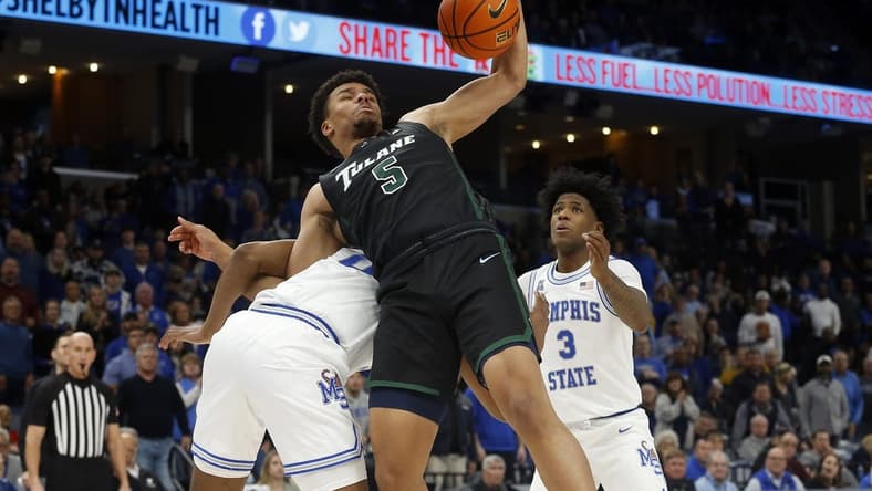 Feb 4, 2023; Memphis, Tennessee, USA; Tulane Green Wave forward Collin Holloway (5) collects a rebound as he is pulled to the ground by Memphis Tigers guard Elijah McCadden (0) during the second half at FedExForum. Mandatory Credit: Petre Thomas-USA TODAY Sports