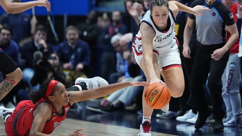 Feb 21, 2023; Hartford, Connecticut, USA; St. John's Red Storm forward Danielle Patterson (3) and Connecticut Huskies guard Caroline Ducharme (33) reach for a loose ball during the second half at XL Center. Mandatory Credit: Gregory Fisher-USA TODAY Sports