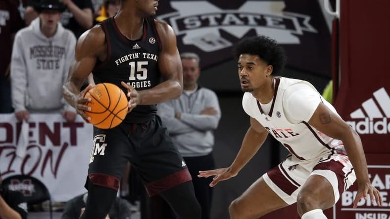 Feb 25, 2023; Starkville, Mississippi, USA; Aggies forward Henry Coleman III (15) handles the ball as Mississippi State Bulldogs forward Tolu Smith (1) defends during the first half at Humphrey Coliseum. Mandatory Credit: Petre Thomas-USA TODAY Sports