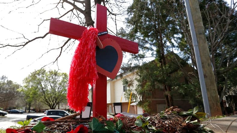 A memorial at the crash site were UGA football player Devin Willock and UGA staffer Chandler LeCroy died in a car crash on Barnett Shoals Road in Athens.