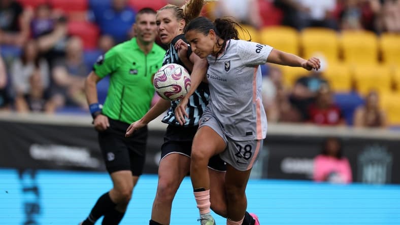 Jul 2, 2023; Harrison, New Jersey, USA; Angel City FC midfielder Lily Nabet (28) goes for the ball during the second half against New Jersey/New York Gotham FC midfielder Allie Long (6) at Red Bull Arena. Mandatory Credit: Vincent Carchietta-USA TODAY Sports