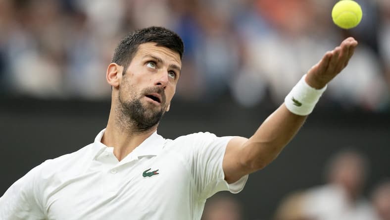 Jul 14, 2023; London, United Kingdom; Novak Djokovic (SRB) tosses the ball to serve during his match against Jannik Sinner (ITA) on day 12 at the All England Lawn Tennis and Croquet Club. Mandatory Credit: Susan Mullane-USA TODAY Sports