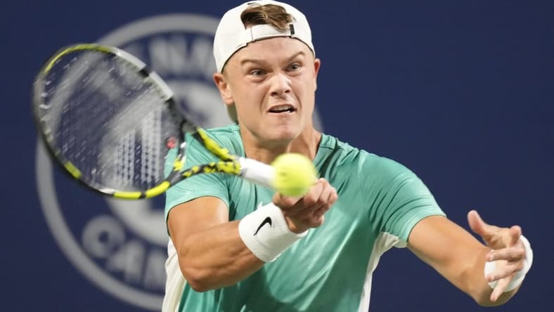 Aug 9, 2023; Toronto, Ontario, Canada; Holger Rune (DEN) hits a ball to Marcos Giron (not pictured) at Sobeys Stadium. Mandatory Credit: John E. Sokolowski-USA TODAY Sports