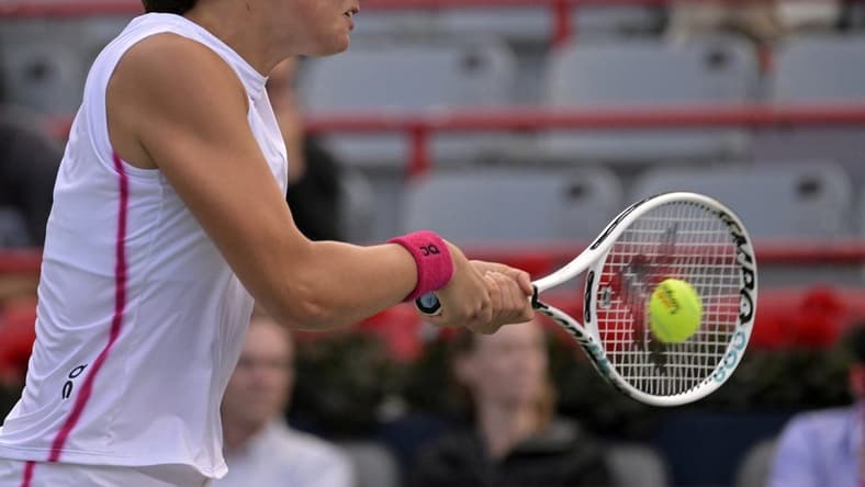 Aug 11, 2023; Montreal, Quebec, Canada; Iga Swiatek (POL) hits a backhand against Danielle Collins (USA) (not pictured) during quarterfinal play at IGA Stadium. Mandatory Credit: Eric Bolte-USA TODAY Sports