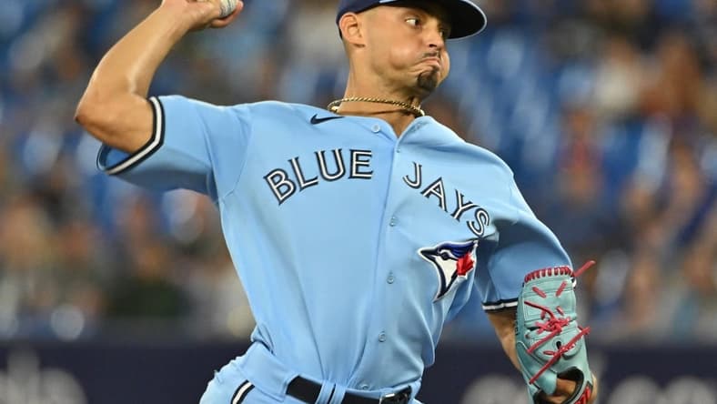 Aug 28, 2023; Toronto, Ontario, CAN; Toronto Blue Jays relief pitcher Jordan Hicks (12) delivers a pitch against the Washington Nationals in the ninth inning at Rogers Centre. Mandatory Credit: Dan Hamilton-USA TODAY Sports