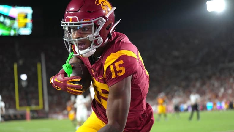 Sep 9, 2023; Los Angeles, California, USA; Southern California Trojans wide receiver Dorian Singer (15) catches a 19-yard touchdown pass against the Stanford Cardinal in the first half at United Airlines Field at Los Angeles Memorial Coliseum. Mandatory Credit: Kirby Lee-USA TODAY Sports
