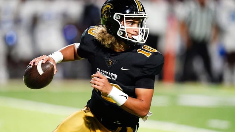 Oct 20, 2023; Carrollton, GA, USA; Carrollton Trojans quarterback Julian Lewis (10) scrambles out of the pocket against the Westlake Lions during the first half at Grisham Stadium. The 15-year-old Carrollton High student has already committed to playing for the University of Southern California Trojans and has been considered one of the top high school quarterback prospects. Mandatory Credit: John David Mercer-USA TODAY Sports