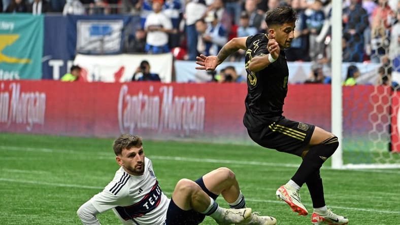 Nov 5, 2023; Vancouver, British Columbia, CAN; Vancouver Whitecaps defender Tristan Blackmon (6) tackles the ball away from Los Angeles FC forward Cristian Olivera (25) during the second half of game two in a round one match of the 2023 MLS Cup Playoffs at BC Place. Mandatory Credit: Simon Fearn-USA TODAY Sports