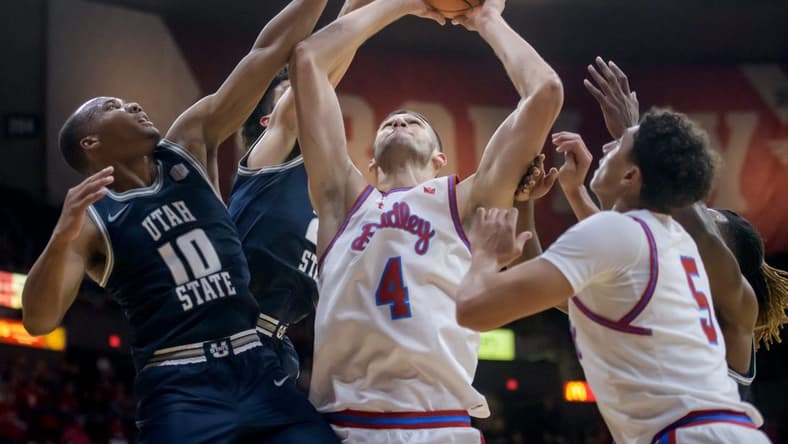 Bradley's Ahmet Jonovic (4) battles for a rebound with Utah State's Darius Brown II (10) in the second half of the Braves' home opener Saturday, Nov. 11, 2023 at Carver Arena.