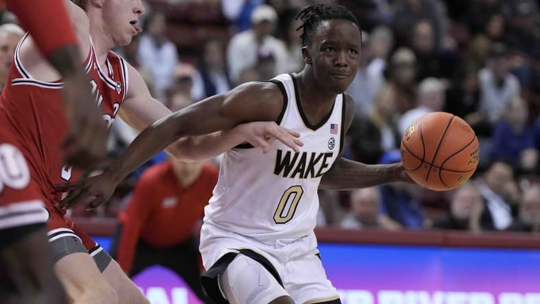 Nov 16, 2023; Charleston, South Carolina, USA; Wake Forest Demon Deacons guard Kevin Miller (0) drives the ball against the Utah Utes in the first half at TD Arena. Mandatory Credit: David Yeazell-USA TODAY Sports
