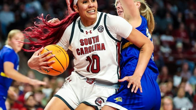 Nov 20, 2023; Columbia, South Carolina, USA; South Carolina Gamecocks center Kamilla Cardoso (10) drives around South Dakota State Jackrabbits forward Brooklyn Meyer (31) in the first half at Colonial Life Arena. Mandatory Credit: Jeff Blake-USA TODAY Sports