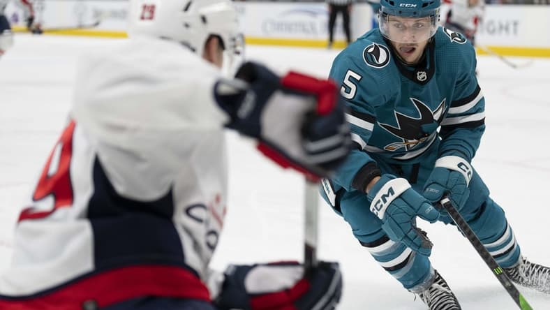 Nov 27, 2023; San Jose, California, USA; San Jose Sharks defenseman Matt Benning (5) defends against Washington Capitals center Hendrix Lapierre (29) during the third period at SAP Center at San Jose. Mandatory Credit: Neville E. Guard-USA TODAY Sports