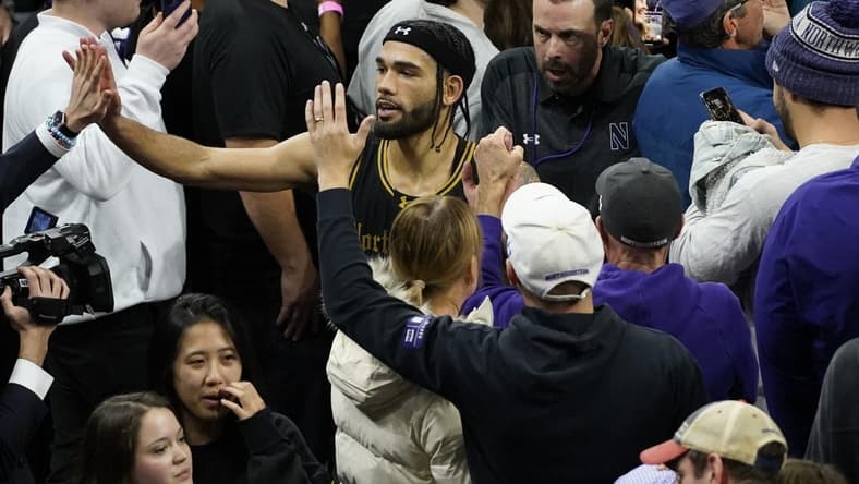 Dec 1, 2023; Evanston, Illinois, USA; Northwestern Wildcats guard Boo Buie (0) celebrates Northwestern   s overtime win against the Purdue Boilermakers at Welsh-Ryan Arena. Mandatory Credit: David Banks-USA TODAY Sports