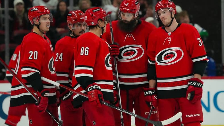 Nov 26, 2023; Raleigh, North Carolina, USA; Carolina Hurricanes center Sebastian Aho (20) center Seth Jarvis (24) left wing Teuvo Teravainen (86) defenseman Brent Burns (8) and right wing Andrei Svechnikov (37) talk against the Columbus Blue Jackets during the third period at PNC Arena. Mandatory Credit: James Guillory-USA TODAY Sports