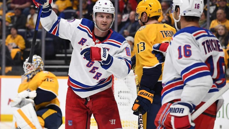 Dec 2, 2023; Nashville, Tennessee, USA; New York Rangers defenseman Jacob Trouba (8) celebrates after a goal against Nashville Predators goaltender Kevin Lankinen (32) during the second period at Bridgestone Arena. Mandatory Credit: Christopher Hanewinckel-USA TODAY Sports