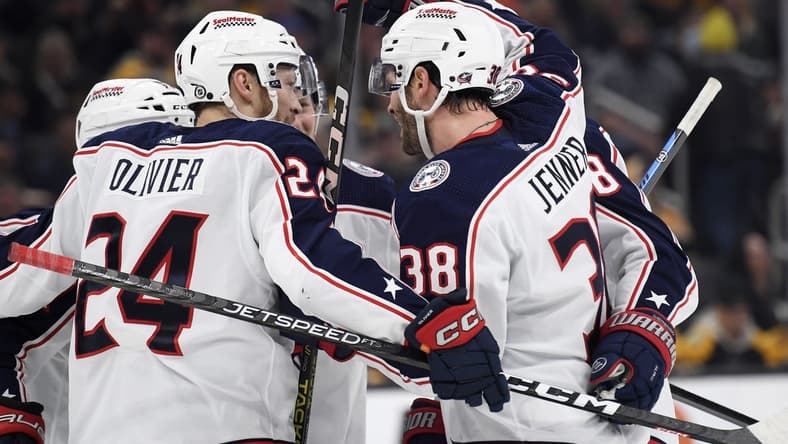 Dec 3, 2023; Boston, Massachusetts, USA; Columbus Blue Jackets center Boone Jenner (38) celebrates his goal with right wing Mathieu Olivier (24) and the rest of his line mates during the second period against the Boston Bruins at TD Garden. Mandatory Credit: Bob DeChiara-USA TODAY Sports