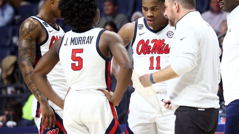 Dec 5, 2023; Oxford, Mississippi, USA; Mississippi Rebels guard TJ Caldwell (2), guard Jaylen Murray (5), guard Matthew Murrell (11) and head coach Chris Beard (right) huddle during a time out during the second half against the Mount St. Mary's Mountaineers at The Sandy and John Black Pavilion at Ole Miss. Mandatory Credit: Petre Thomas-USA TODAY Sports