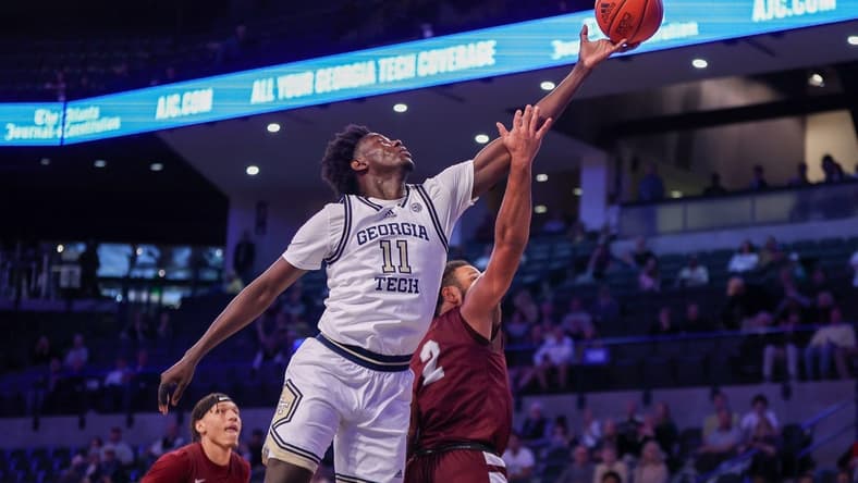 Dec 9, 2023; Atlanta, Georgia, USA; Georgia Tech Yellow Jackets forward Baye Ndongo (11) reaches for a rebound over Alabama A&M Bulldogs guard Omari Peek (2) in the first half at McCamish Pavilion. Mandatory Credit: Brett Davis-USA TODAY Sports