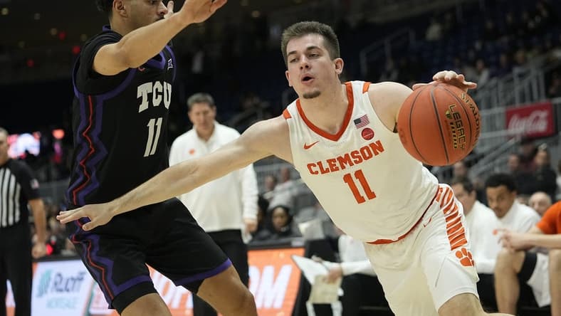 Dec 9, 2023; Toronto, Ontario, CAN; Clemson Tigers guard Joseph Girard III (11) drives against TCU Horned Frogs guard Trevian Tennyson (11) during the second half at Coca-Cola Coliseum. Mandatory Credit: John E. Sokolowski-USA TODAY Sports