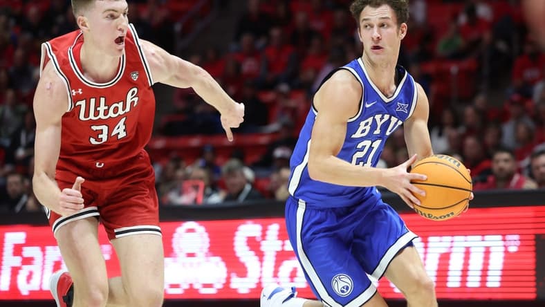 Dec 9, 2023; Salt Lake City, Utah, USA; Brigham Young Cougars guard Trevin Knell (21) dribble past Utah Utes center Lawson Lovering (34) during the first half at Jon M. Huntsman Center. Mandatory Credit: Rob Gray-USA TODAY Sports