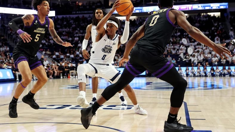 Dec 9, 2023; Norfolk, Virginia, USA; Old Dominion Monarchs guard Vasean Allette (0) drives to the basket against James Madison Dukes guard Terrence Edwards (5) and guard Xavier Brown (0) during the second half at Chartway Arena at the Ted Constant Convocation Center. Mandatory Credit: Peter Casey-USA TODAY Sports