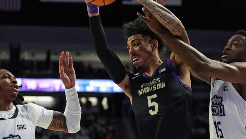 Dec 9, 2023; Norfolk, Virginia, USA; James Madison Dukes guard Terrence Edwards (5) drives to the basket against Old Dominion Monarchs guard Chaunce Jenkins (2) guard R.J. Blakney (15) at Chartway Arena at the Ted Constant Convocation Center. Mandatory Credit: Peter Casey-USA TODAY Sports