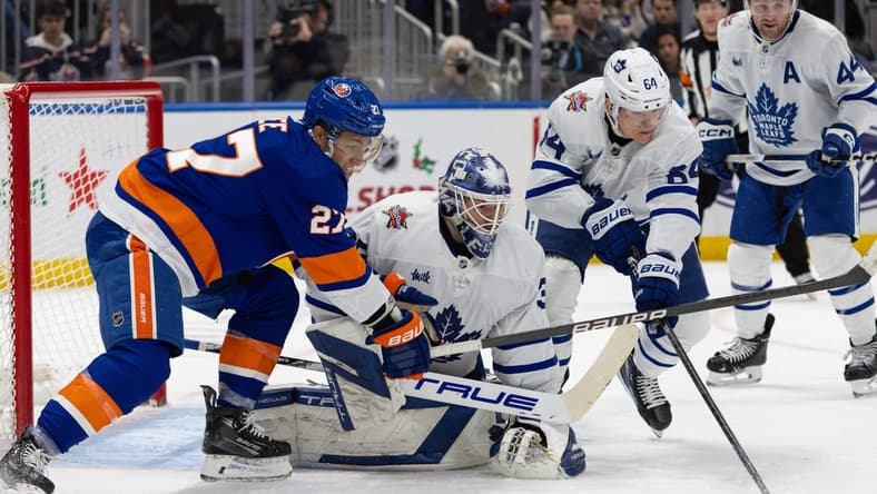 Dec 11, 2023; Elmont, New York, USA; Toronto Maple Leafs goaltender Ilya Samsonov (35) tracked the puck while New York Islanders left wing Anders Lee (27) attempts to score during the second period at UBS Arena. Mandatory Credit: Thomas Salus-USA TODAY Sports