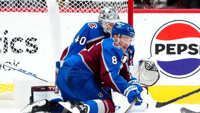 2Dec 11, 2023; Denver, Colorado, USA; Colorado Avalanche defenseman Cale Makar (8) and Colorado Avalanche goaltender Alexandar Georgiev (40) reach for the puck in the second period against the Calgary Flames at Ball Arena. Mandatory Credit: Ron Chenoy-USA TODAY Sports