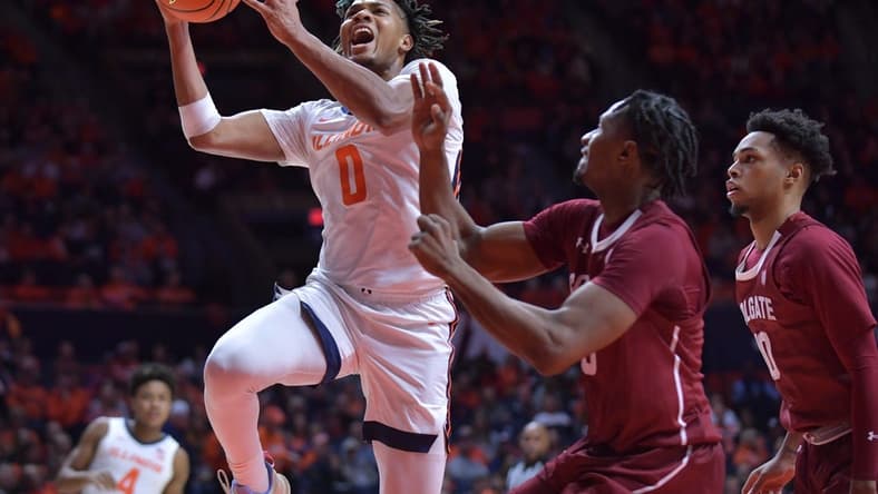 Dec 17, 2023; Champaign, Illinois, USA; Illinois Fighting Illini guard Terrence Shannon Jr. (0) drives to the basket against Colgate Raiders players during the first half at State Farm Center. Mandatory Credit: Ron Johnson-USA TODAY Sports