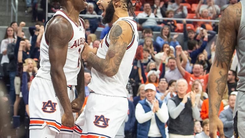 Auburn Tigers forward Jaylin Williams (2) and center Johni Broome (4) celebrate Williams alley-op dunk as Auburn Tigers take on Alabama State Hornets at Neville Arena in Auburn, Ala., on Friday, Dec. 22, 2023. Auburn Tigers defeated Alabama State Hornets 82-62.