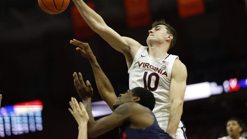 Dec 27, 2023; Charlottesville, Virginia, USA; Virginia Cavaliers guard Taine Murray (10) blocks the shot of Morgan State Bears guard Amahrie Simpkins (11) in the first half at John Paul Jones Arena. Mandatory Credit: Geoff Burke-USA TODAY Sports