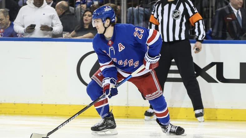 Dec 27, 2023; New York, New York, USA; New York Rangers defenseman Adam Fox (23) controls the puck in the third period against the Washington Capitals at Madison Square Garden. Mandatory Credit: Wendell Cruz-USA TODAY Sports