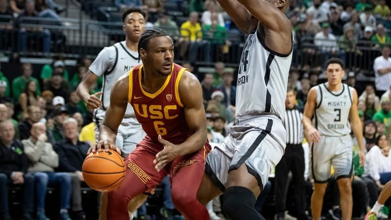 USC guard Bronny James drives under the basket under coverage from Oregon center Mahamadou Diawara as the Oregon Ducks host the USC Trojans Thursday, Dec. 28, 2023, at Matthew Knight Arena in Eugene, Ore.