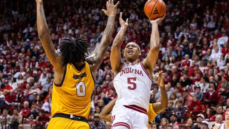 Dec 29, 2023; Bloomington, Indiana, USA; Indiana Hoosiers forward Malik Reneau (5) shoots the ball while Kennesaw State Owls forward Demond Robinson (0) and guard Terrell Burden (1) defend in the first half at Simon Skjodt Assembly Hall. Mandatory Credit: Trevor Ruszkowski-USA TODAY Sports