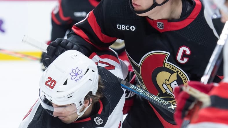 Dec 29, 2023; Ottawa, Ontario, CAN; New Jersey Devils center Michael McLeod (20) faces off against Ottawa Senators left wing Brady Tkachuk (7) in the first period at the Canadian Tire Centre. Mandatory Credit: Marc DesRosiers-USA TODAY Sports