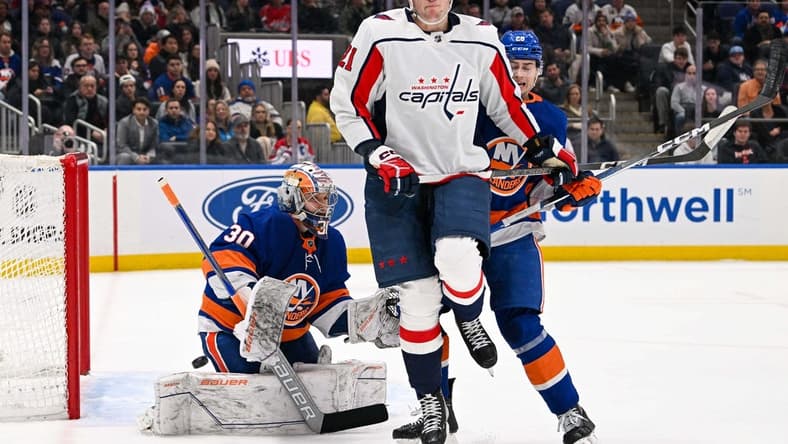 Dec 29, 2023; Elmont, New York, USA; New York Islanders goaltender Ilya Sorokin (30) makes a save as Washington Capitals center Aliaksei Protas (21) attempts s screen during the first period at UBS Arena. Mandatory Credit: Dennis Schneidler-USA TODAY Sports
